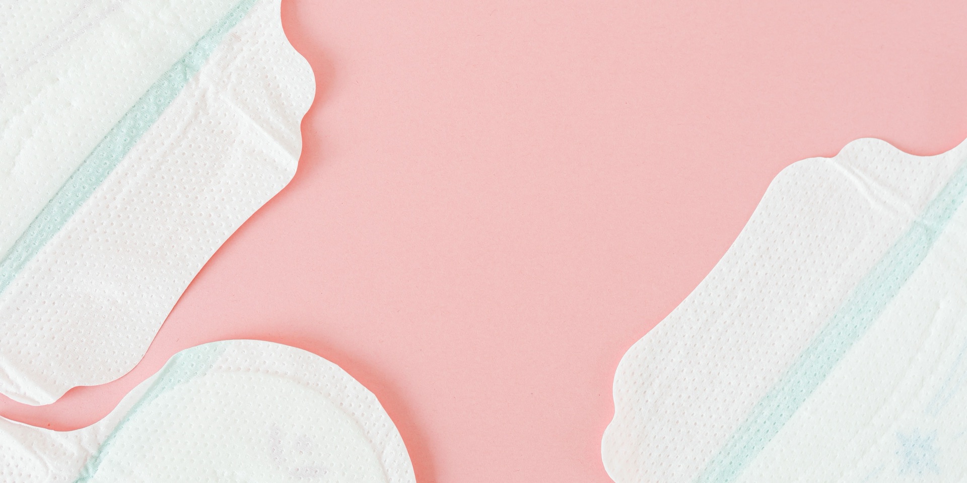White sanitary pads with wings on a pink background